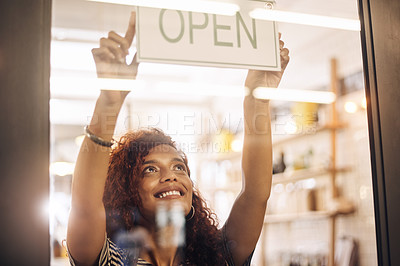 Buy stock photo Open, sign and happy woman at window of shop, store and notice of retail shopping time, board and welcome. Small business owner, female worker and advertising opening information to start services