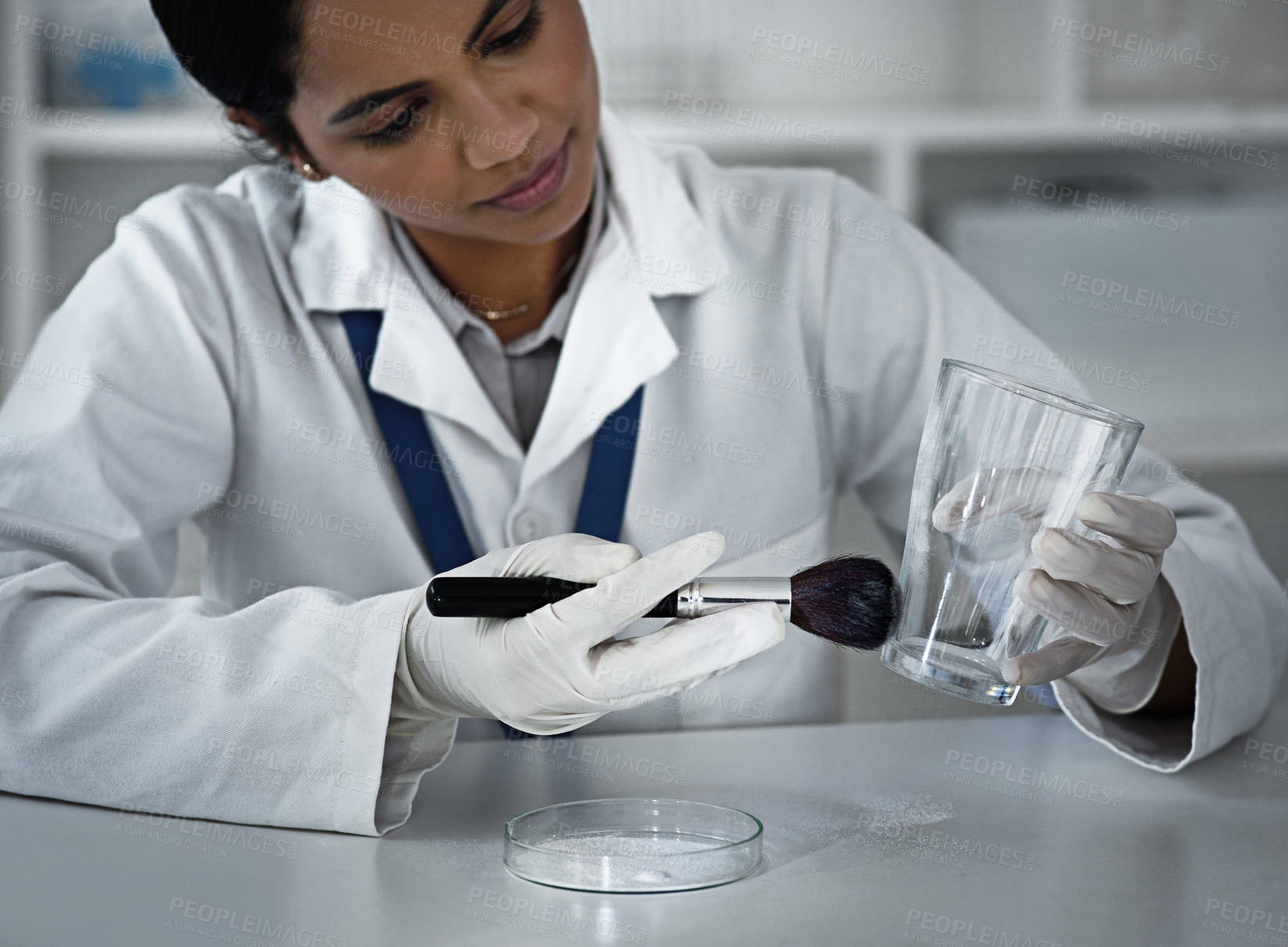 Buy stock photo High angle shot of a female forensic scientist dusting for prints in the lab