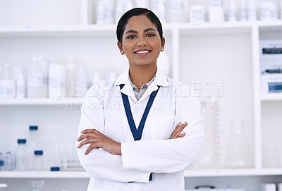 Buy stock photo Cropped portrait of an attractive young female scientist standing with her arms folded in the lab