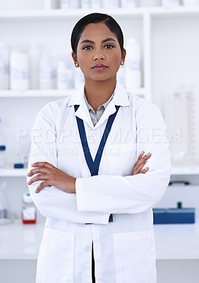 Buy stock photo Cropped portrait of an attractive young female scientist standing with her arms folded in the lab