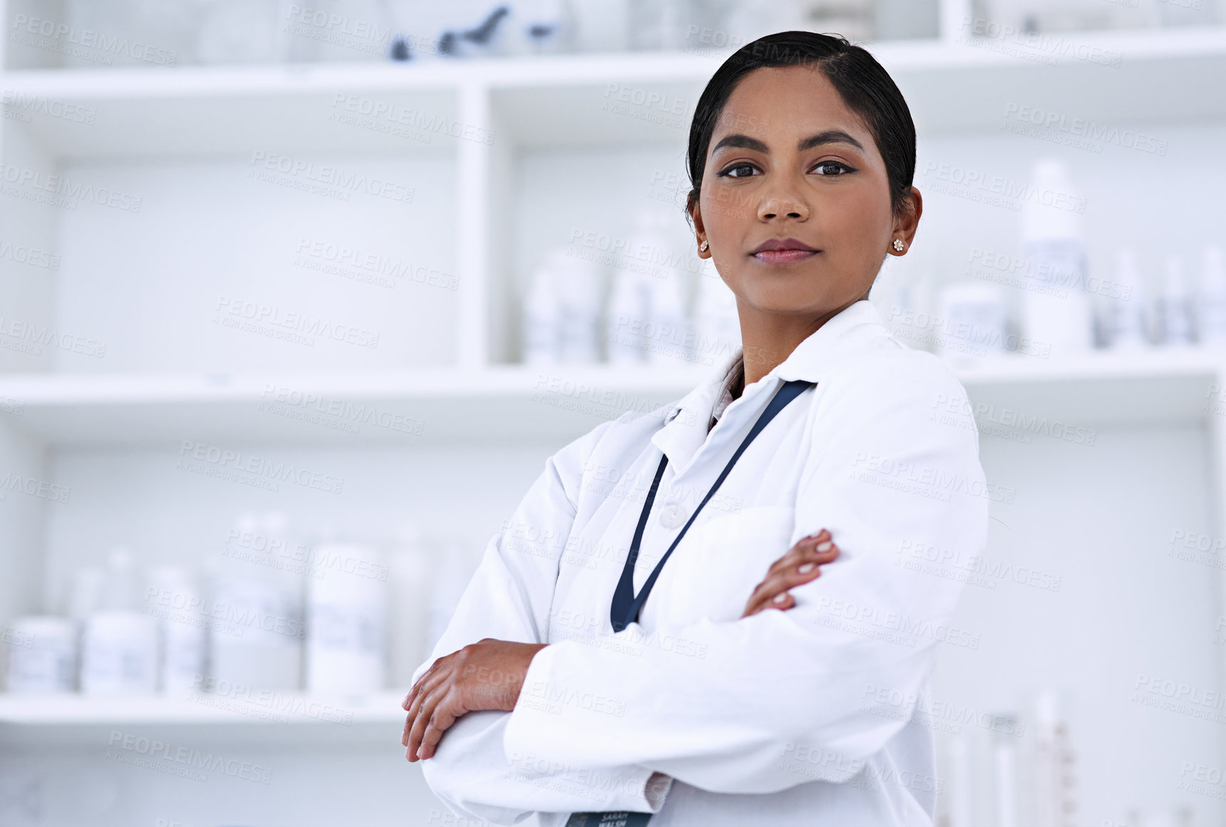 Buy stock photo Cropped portrait of an attractive young female scientist standing with her arms folded in the lab