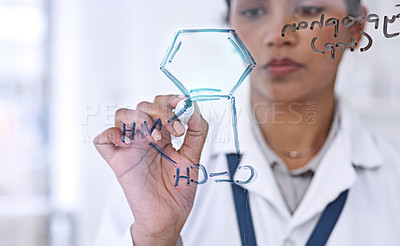 Buy stock photo Cropped shot of an attractive young female scientist working on formulas in her laboratory