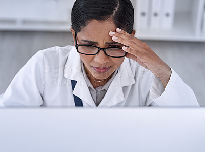 Buy stock photo Cropped shot of an attractive young female scientist looking stressed while working in her laboratory
