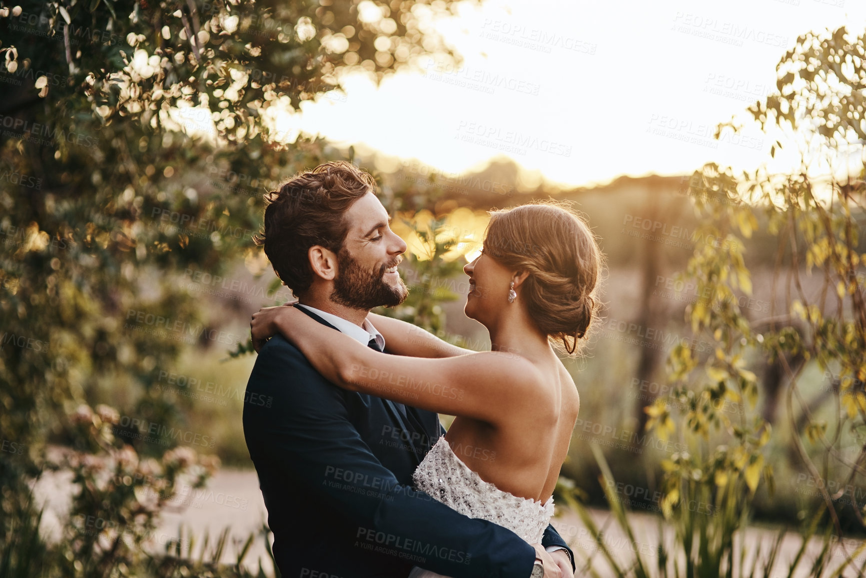 Buy stock photo Happy married couple, hug and smile for wedding, marriage or commitment in relationship together in nature. Groom and bride hugging, smiling and embracing love, vows or honeymoon adventure outside