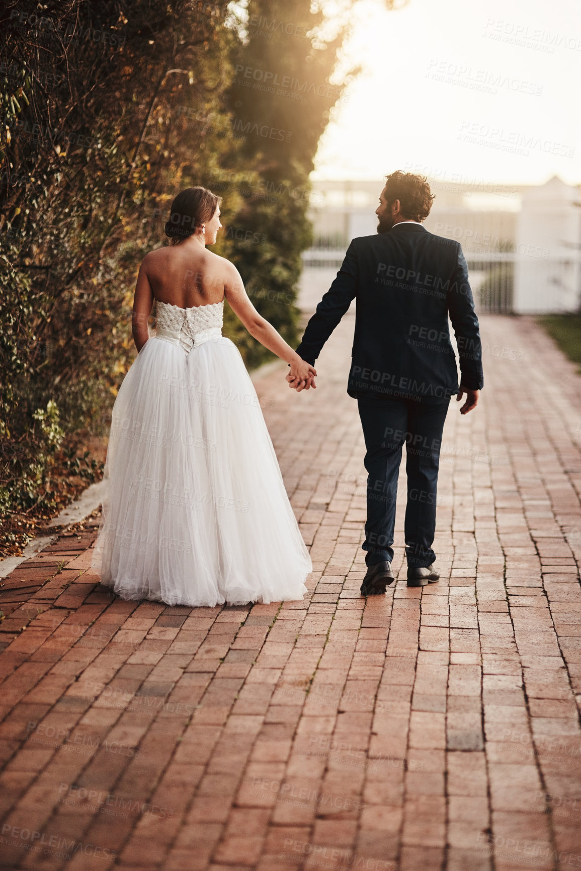 Buy stock photo Wedding, couple holding hands outdoor with marriage, life partner with happy bride and groom in park. Love, event and celebration with peace, calm and partnership, man and woman back view at sunset