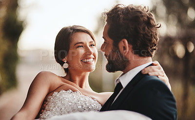 Buy stock photo Couple, love and bonding at wedding, marriage event or ceremony vows, union or commitment in sunset nature park. Smile, happy and groom carrying bride in celebration, security or partnership support