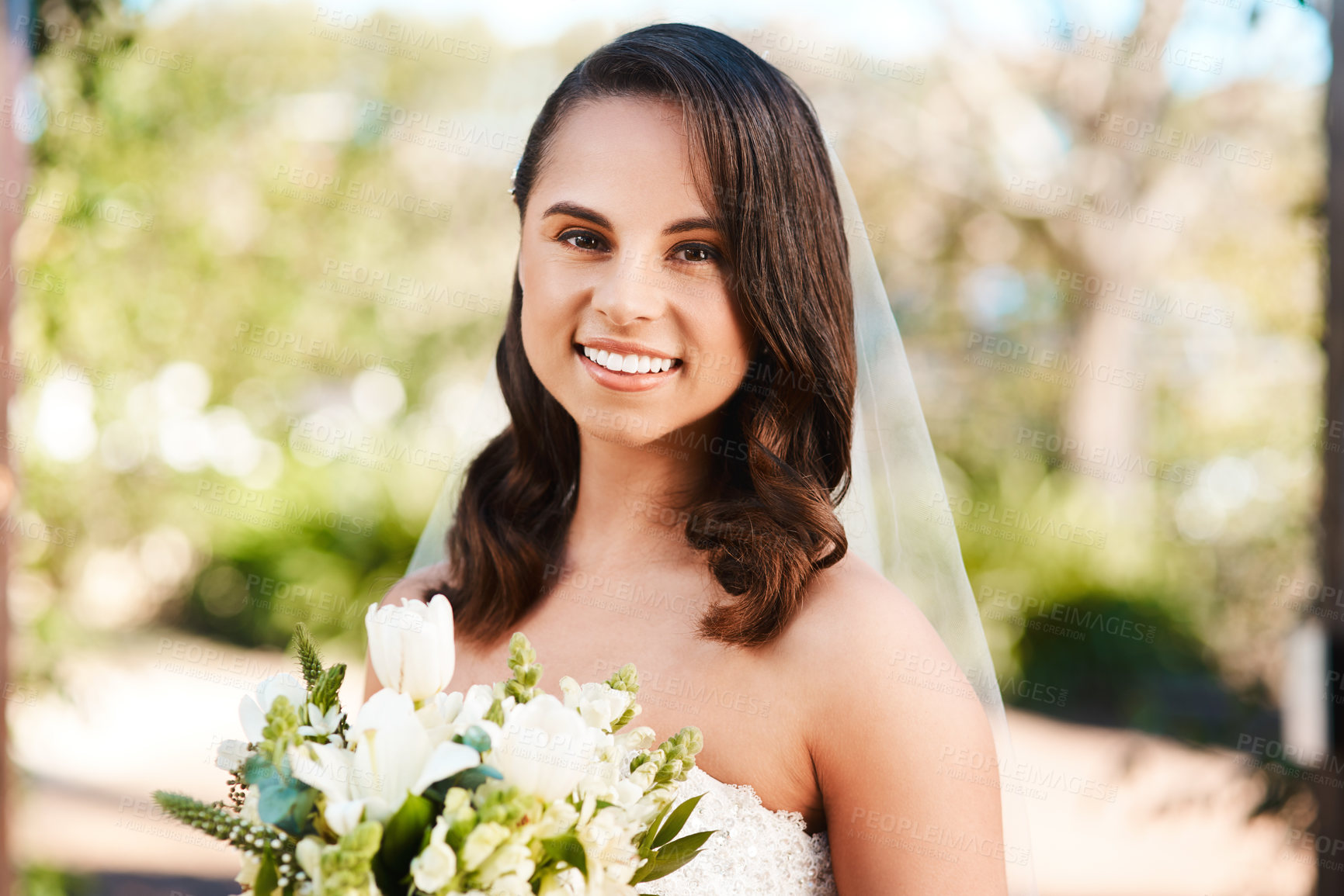 Buy stock photo Cropped portrait of a beautiful young bride smiling while holding a bouquet of flowers on her wedding day