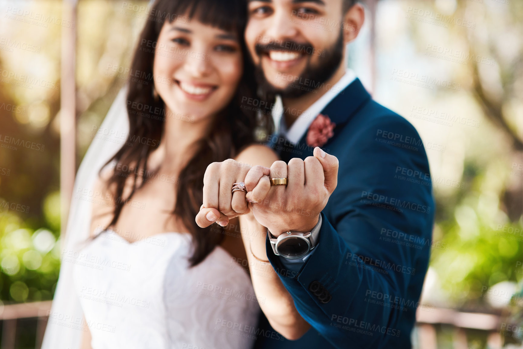 Buy stock photo Cropped shot of an affectionate young newlywed couple doing a pinky swear gesture while standing outdoors on their wedding day