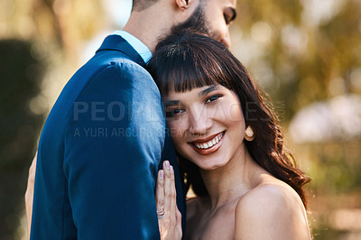 Buy stock photo Cropped shot of an affectionate young bride smiling while leaning on her groom's chest on their wedding day
