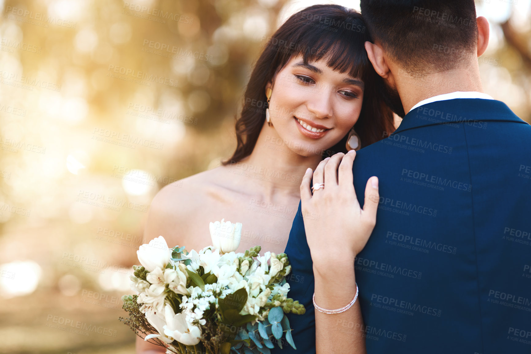 Buy stock photo Calm, couple and love at sunset with wedding on hand of bride with flowers, bouquet or marriage. Loyalty, commitment and support of groom in embrace or hug outdoor at event for engagement