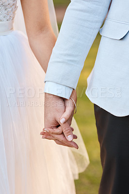 Buy stock photo Cropped shot of an unrecognizable couple holding hands on their wedding day