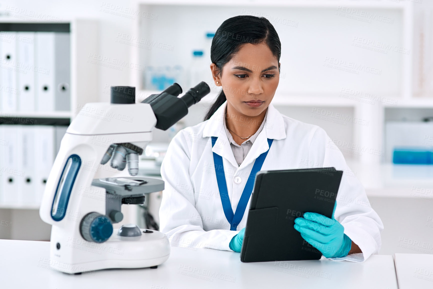 Buy stock photo Reading, tablet and woman in lab for science, research and microscope for biotechnology. Female scientist, thinking and technology at table for information, update and consultation or chemistry
