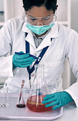 Buy stock photo Cropped shot of an attractive young female scientist conducting an experiment with a red liquid in a laboratory