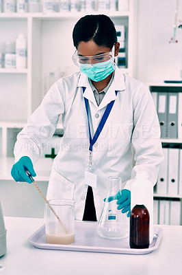 Buy stock photo Cropped shot of an attractive young female scientist conducting an experiment with a liquid in a laboratory