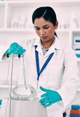 Buy stock photo Cropped shot of an attractive young female scientist working with a centrifuge in a laboratory