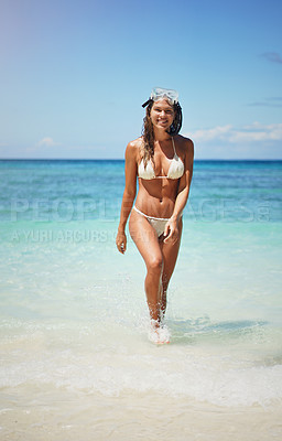 Buy stock photo Full length portrait of an attractive young woman in scuba gear walking from the ocean onto the beach