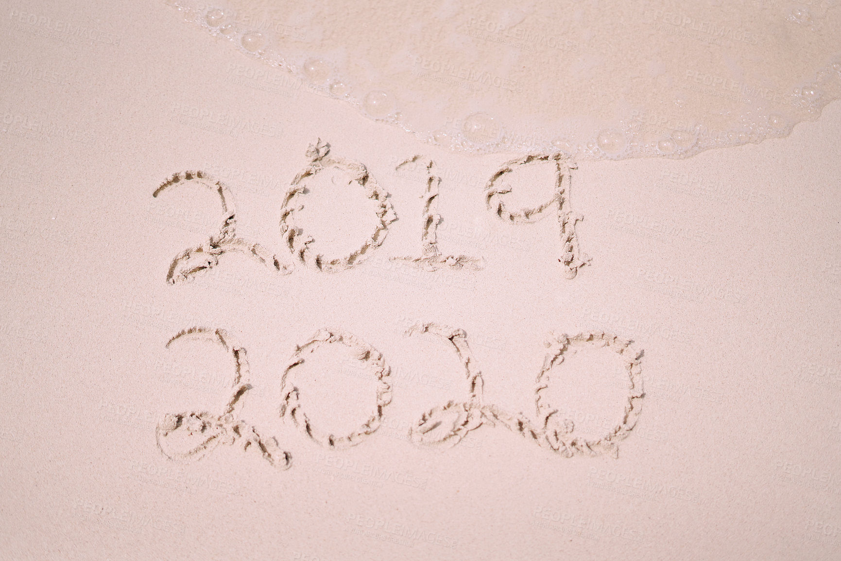 Buy stock photo Still life shot of the years 2019 and 2020 written on sand on a beach in Raja Ampat, Indonesia
