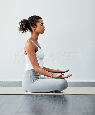 Buy stock photo Shot of a sporty young woman practising yoga