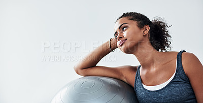 Buy stock photo Studio shot of an attractive young woman taking a break during a workout against a grey background