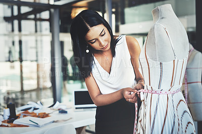 Buy stock photo Shot of a successful young fashion designer working on her latest design