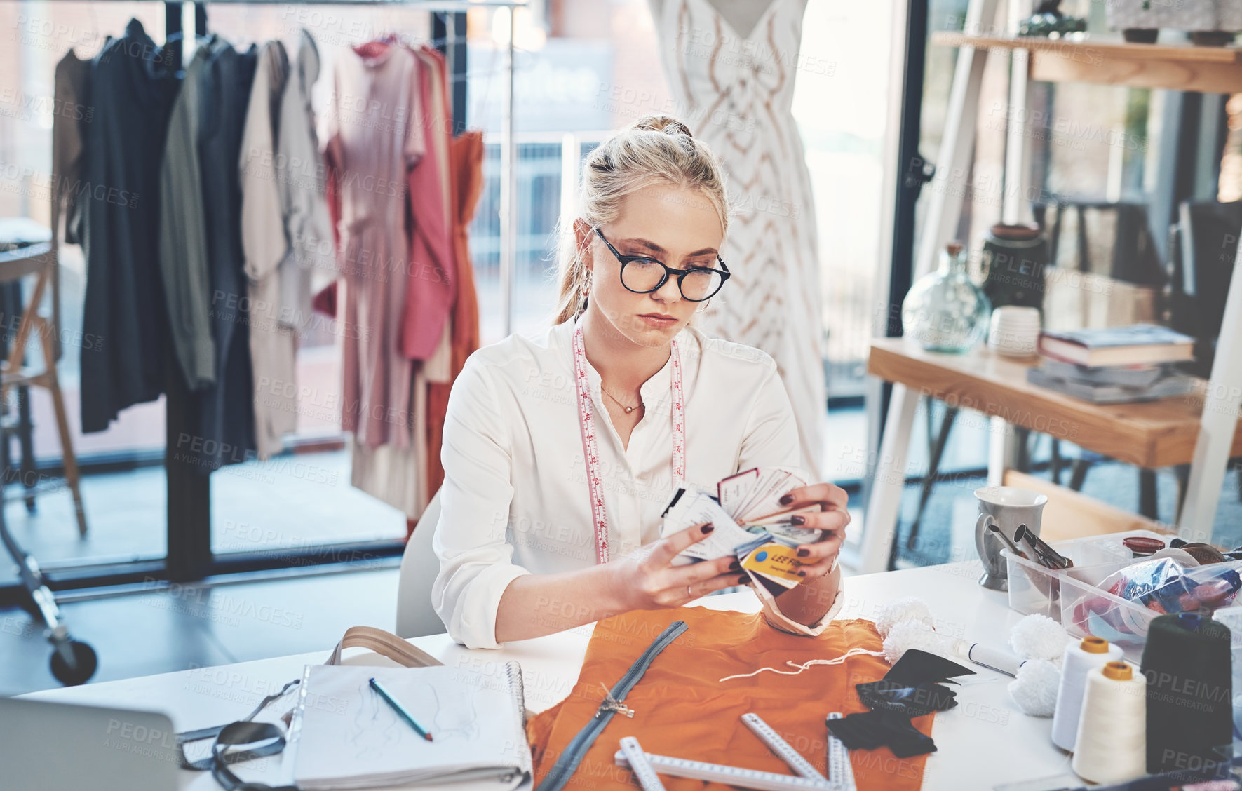 Buy stock photo Shot of a successful young fashion designer in her workshop