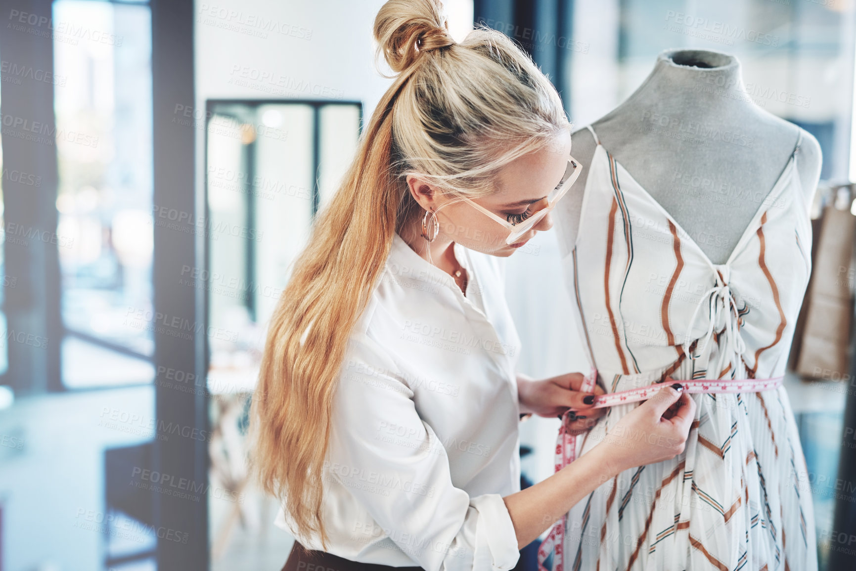 Buy stock photo Shot of a successful young fashion designer working on her latest design