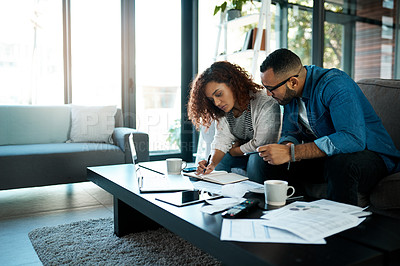 Buy stock photo Couple working on budget, finance and bills with notes on payment for loan, mortgage and debt while at home. Financial review of spending, income and savings with man and woman writing in notebook