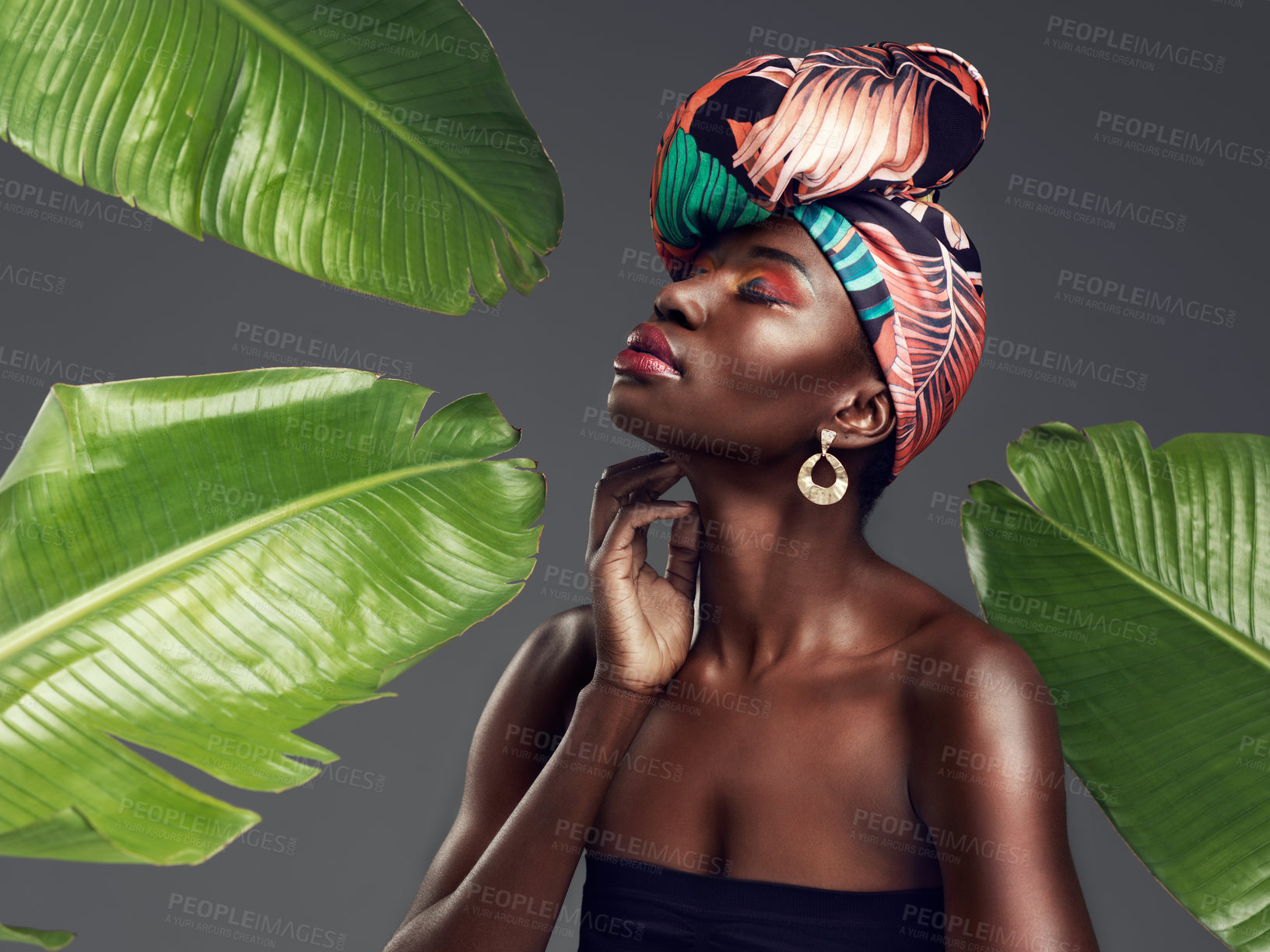 Buy stock photo Black woman in African turban, fashion with leaves and beauty with makeup on studio background. Natural cosmetics, nature aesthetic and female model with traditional head wrap, creativity and style