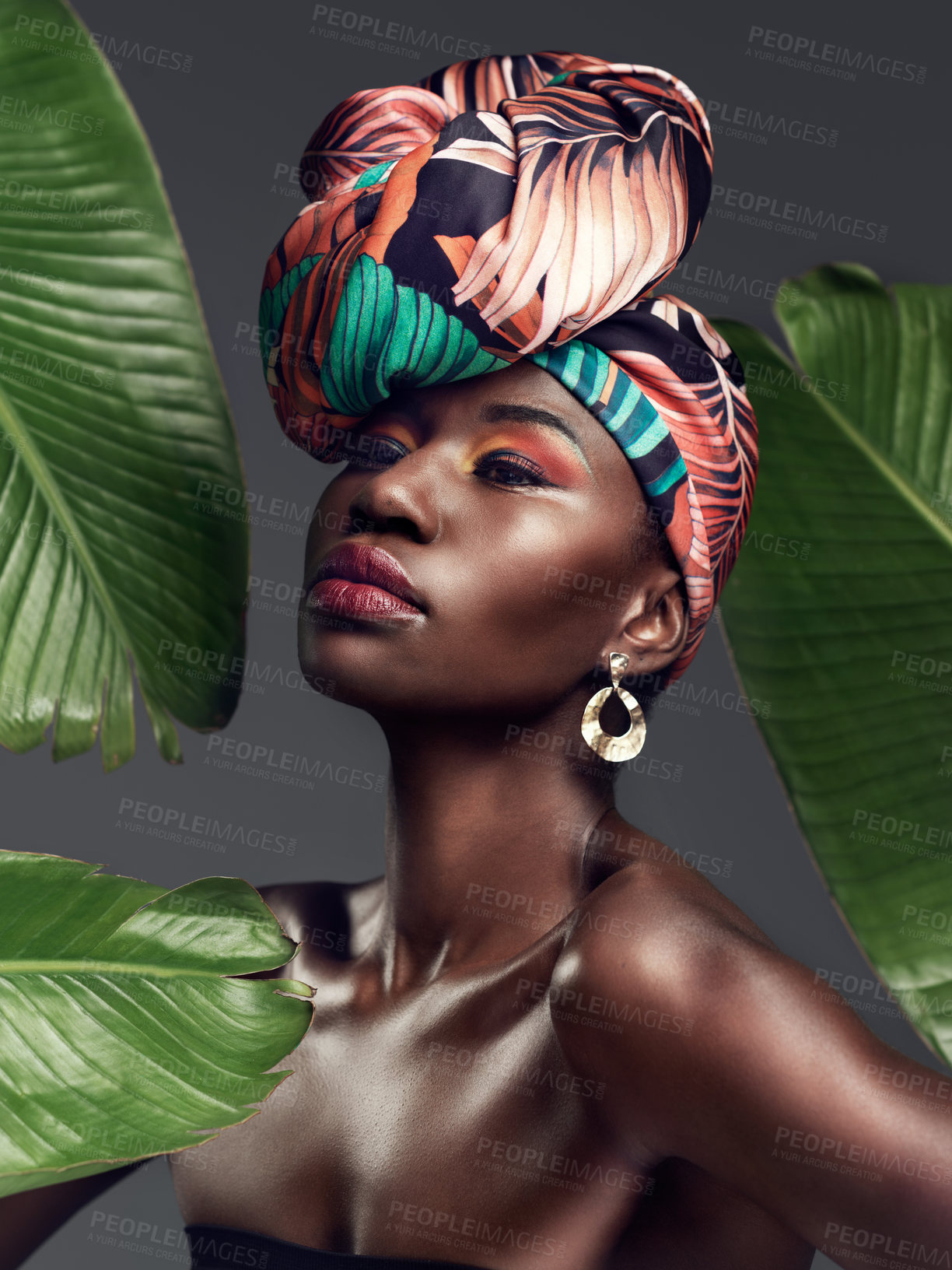 Buy stock photo Black woman in traditional turban, fashion with leaves and beauty with makeup on studio background. Natural cosmetics, nature aesthetic and female model with African head wrap, creativity and style