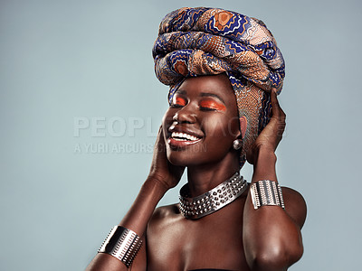 Buy stock photo Beauty, black woman and smile with African head scarf and mockup in a studio. Isolated, blue background traditional Africa turban with a young female model with culture and pride with cosmetics
