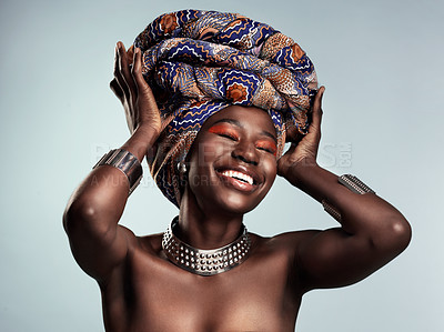 Buy stock photo Beauty, black woman and laughing with African turban and smile in a studio. Isolated, grey background traditional makeup with a young female model with culture crown and fashion with cosmetics
