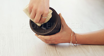 Buy stock photo Cropped shot of an unrecognizable woman cleaning her camera lens at home