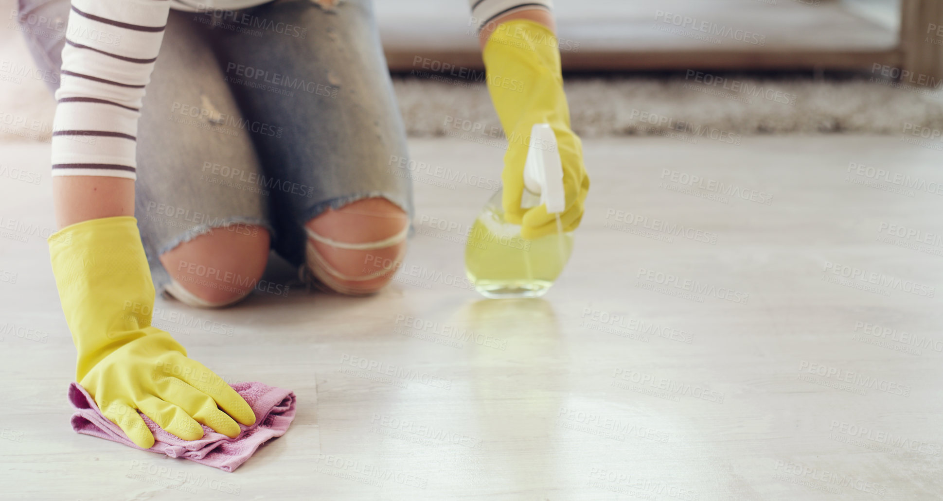 Buy stock photo Cropped shot of a young woman cleaning her floors at home
