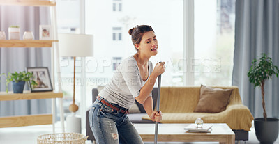 Buy stock photo Cropped shot of a young woman mopping the floor in her living room