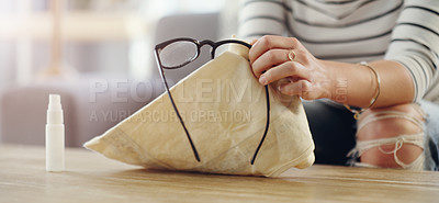 Buy stock photo Hand, closeup of woman cleaning glasses and spray bottle with chemical liquid, fabric cloth and hygiene. Clean spectacles, eyewear and female cleaner at home with eye care with lens maintenance
