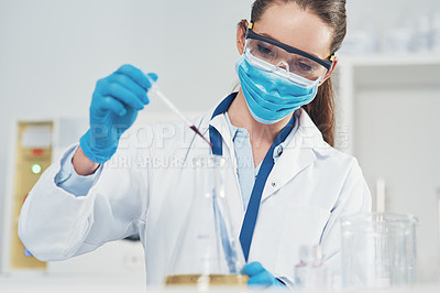 Buy stock photo Cropped shot of an unrecognizable young female scientist wearing protective face gear while conducting experiments inside of a laboratory