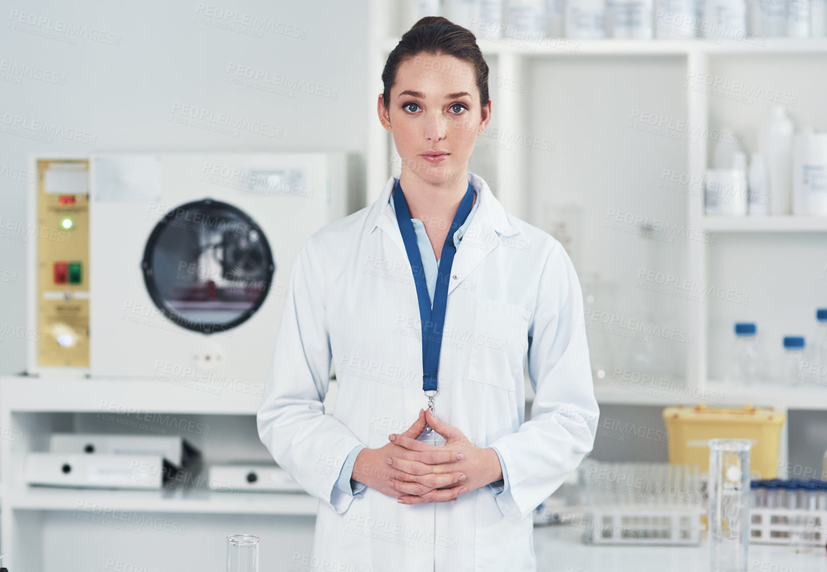 Buy stock photo Portrait of a confident young female scientist standing at her workstation ready to conduct experiments inside of a laboratory