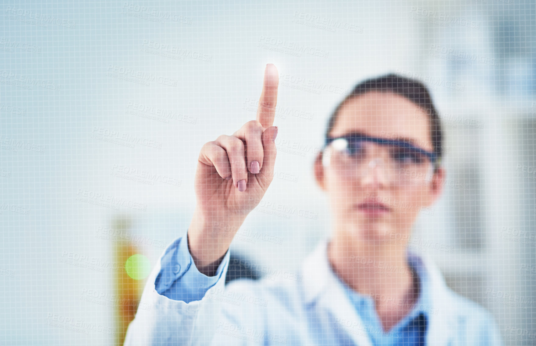 Buy stock photo Cropped shot of a focused young female scientist wearing protective glasses while pointing with her finger on a glass wall