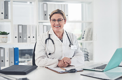 Buy stock photo Cropped portrait of an attractive young female doctor smiling while sitting in her office