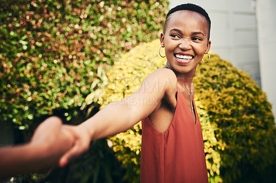 Buy stock photo Cropped shot of a happy young woman pulling her partner by the hand
