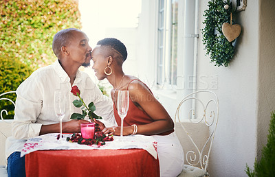 Buy stock photo Cropped shot of a happy  young couple having a romantic dinner outside