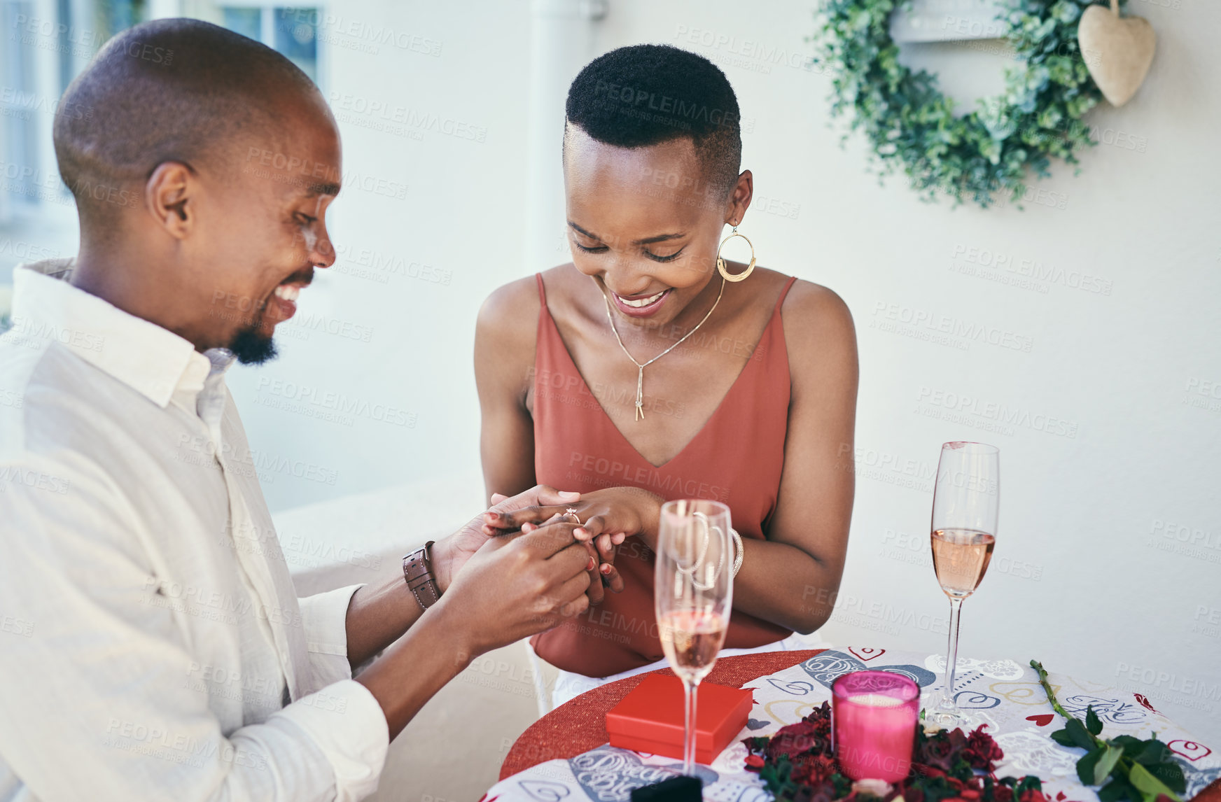 Buy stock photo Shot of a young man proposing to his his girlfriend on a romantic date