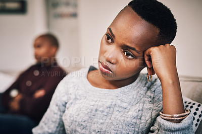 Buy stock photo Shot of an attractive young woman looking upset after having an argument with her boyfriend at home