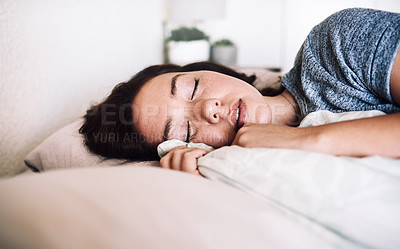 Buy stock photo Cropped shot of an attractive young woman sleeping on her bed in the morning at home