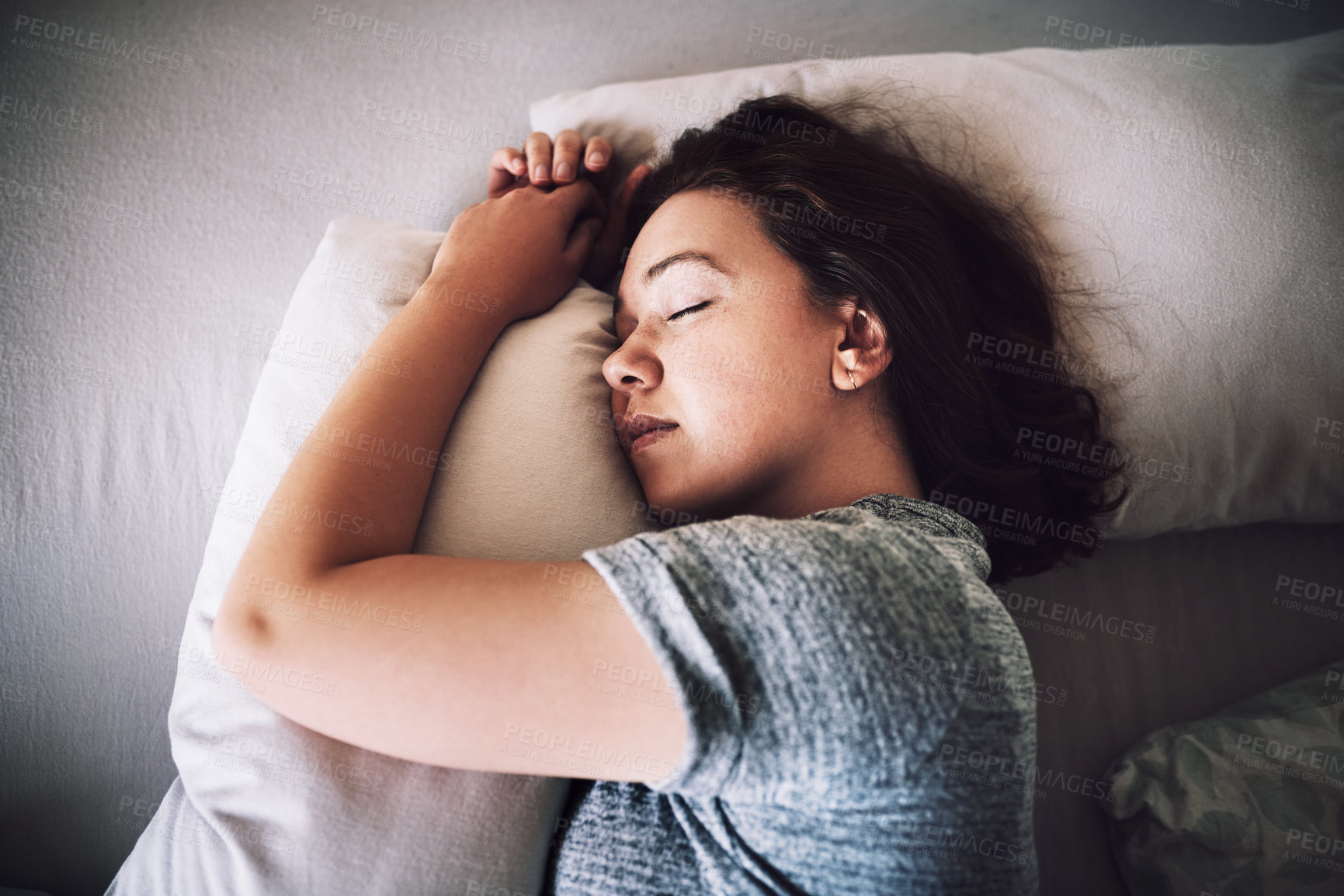 Buy stock photo High angle shot of an attractive young woman sleeping on her bed in the morning at home