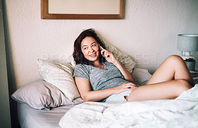 Buy stock photo Cropped shot of an attractive young woman smiling while taking a phonecall in her bedroom at home