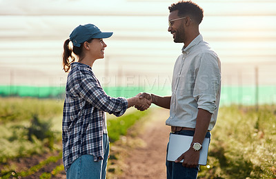 Buy stock photo Cropped shot of two young farmers shaking hands while working on their farm
