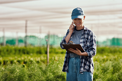 Buy stock photo Cropped shot of an attractive young female farmer making a phonecall while working on her farm