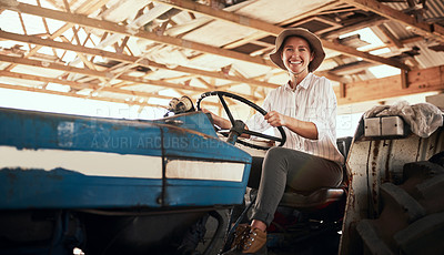 Buy stock photo Portrait of an attractive young female farmer posing while siting inside a tractor at her farm