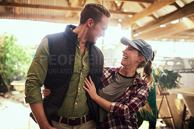 Buy stock photo Shot of a happy young couple relaxing together at their farm